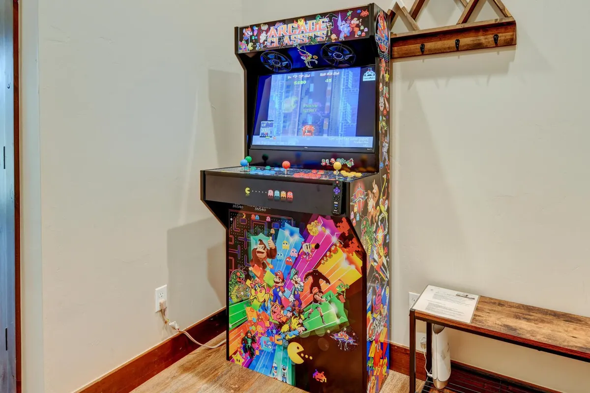 A classic arcade game machine stands ready for play, inviting guests to enjoy nostalgic gaming sessions and socializing in a modern setting.